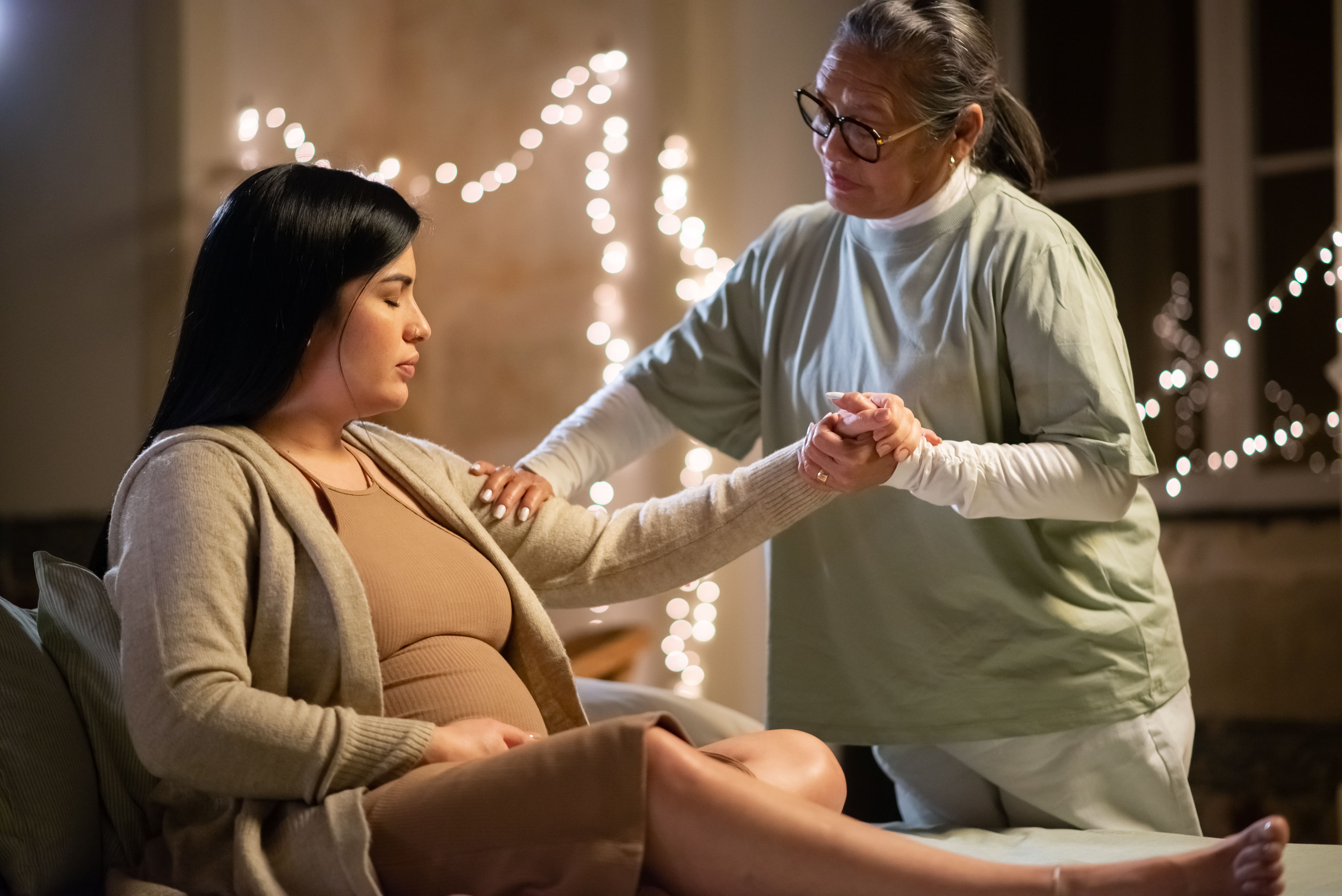 side-view-pregnant-woman-midwife-home-woman-casual-clothes-sitting-bed-asian-doula-holding-hand-pregnancy-medicine-home-birth-concept (1).jpg